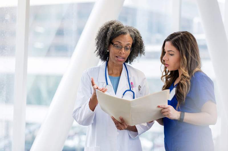 Doctor Reviews Certification With Employee 31