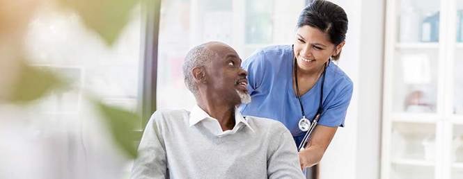 Patient Care Tech Helping Patient