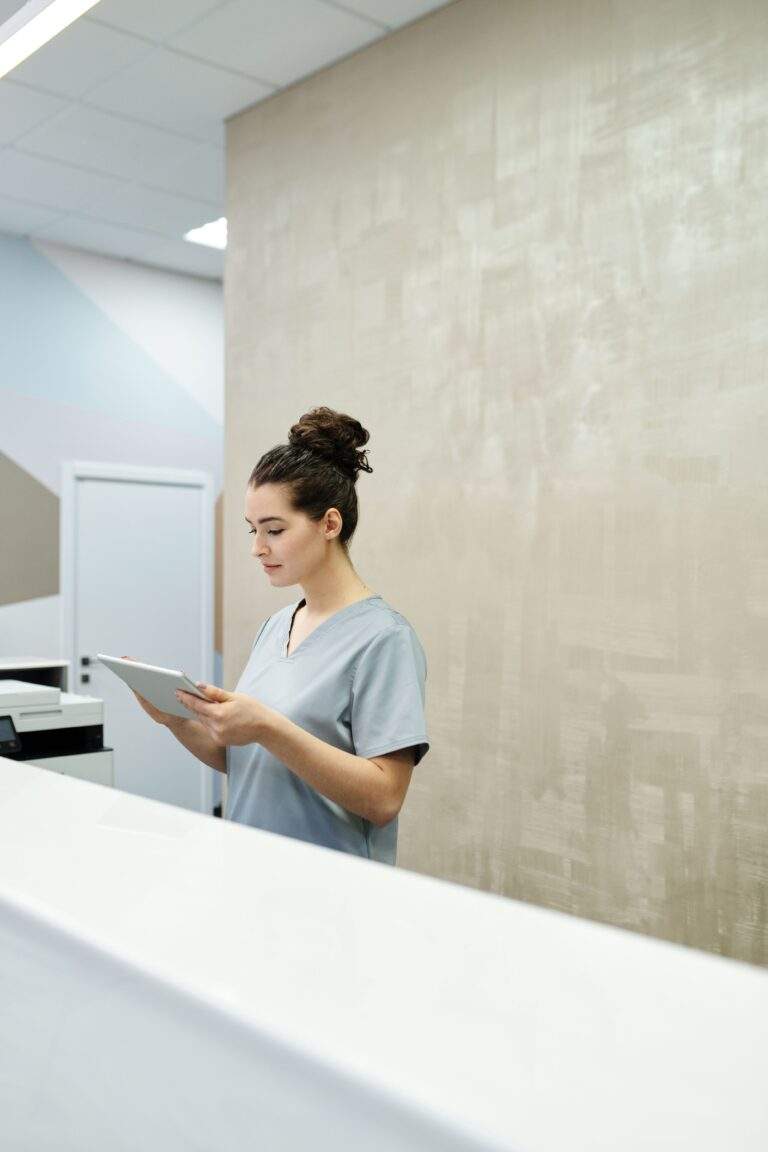 Medical office professional working at a clinic reception desk