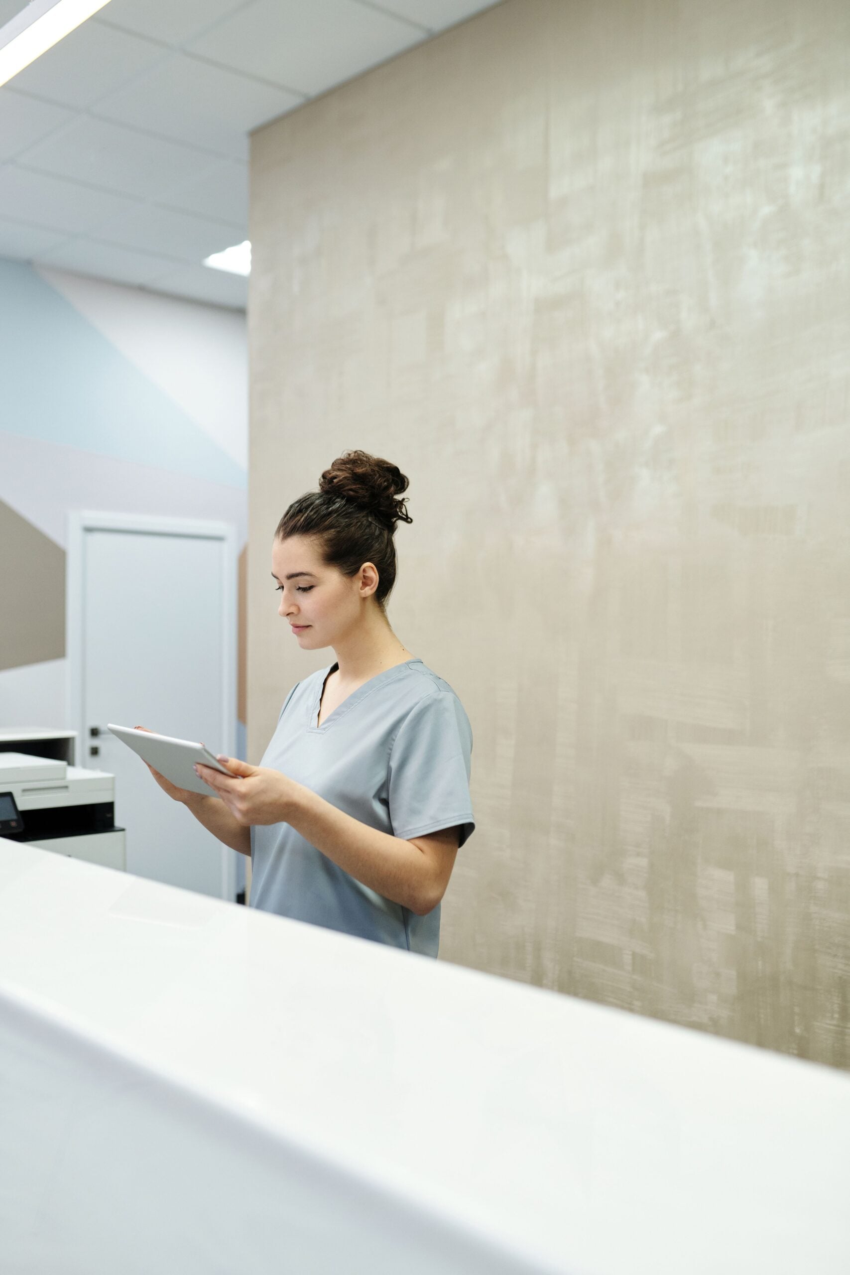 Medical office professional working at a clinic reception desk