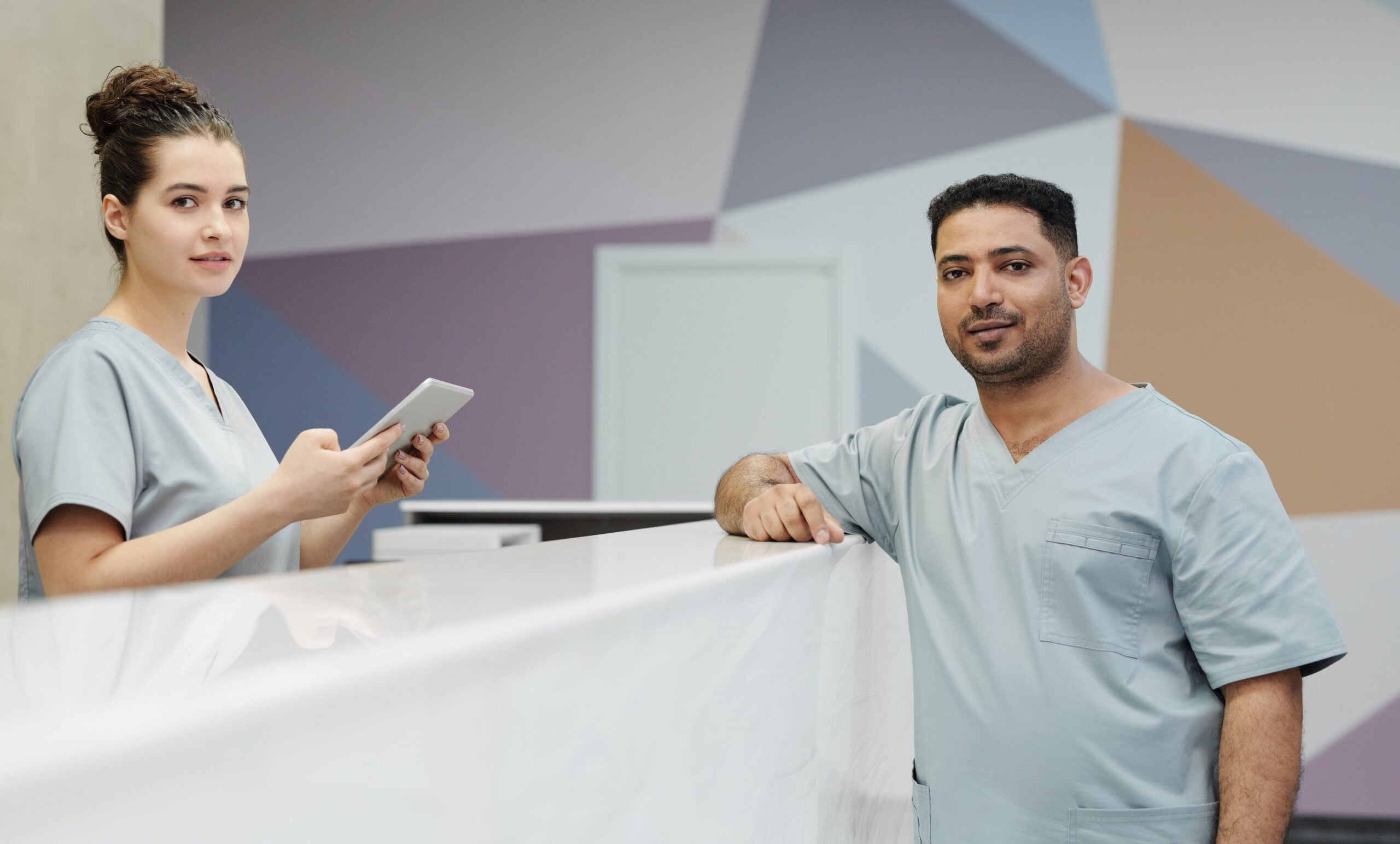 Medical office staff working together at a modern clinic reception desk