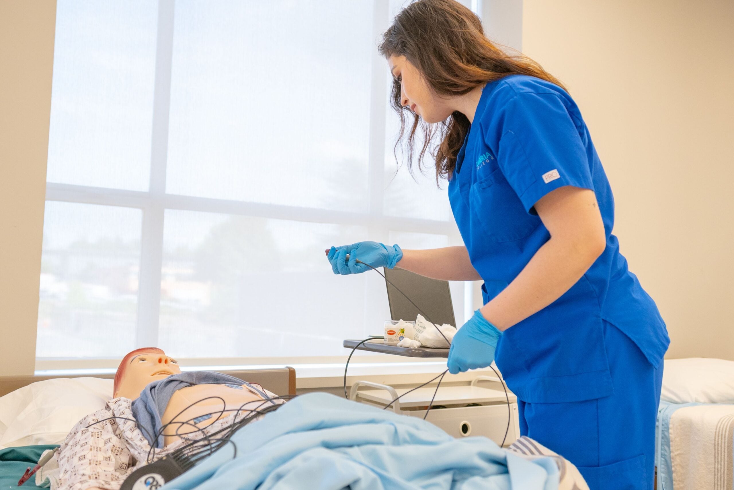 Healthcare learner in scrubs participating in professional skills training