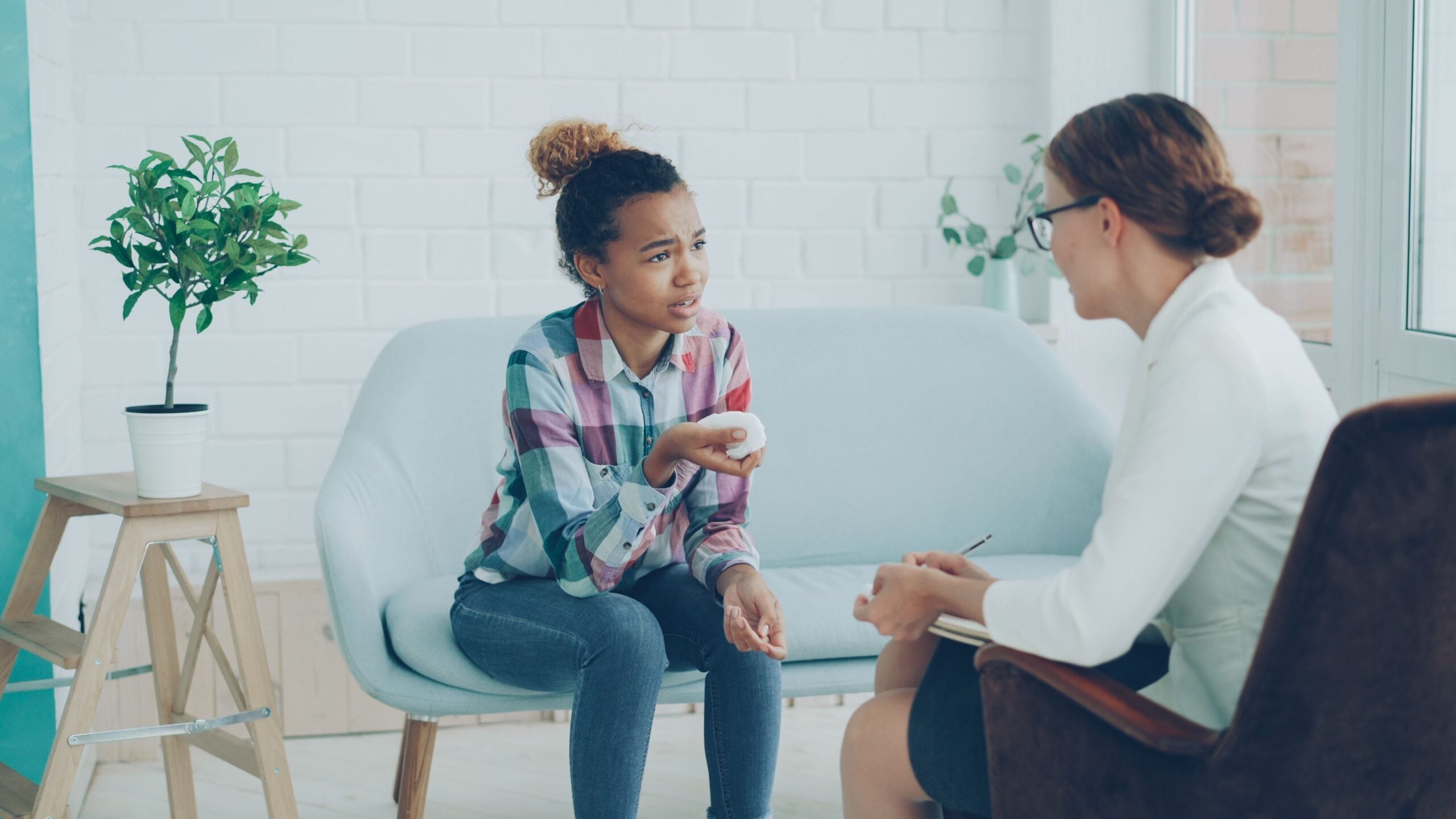 Counselor speaking with a client in a professional office