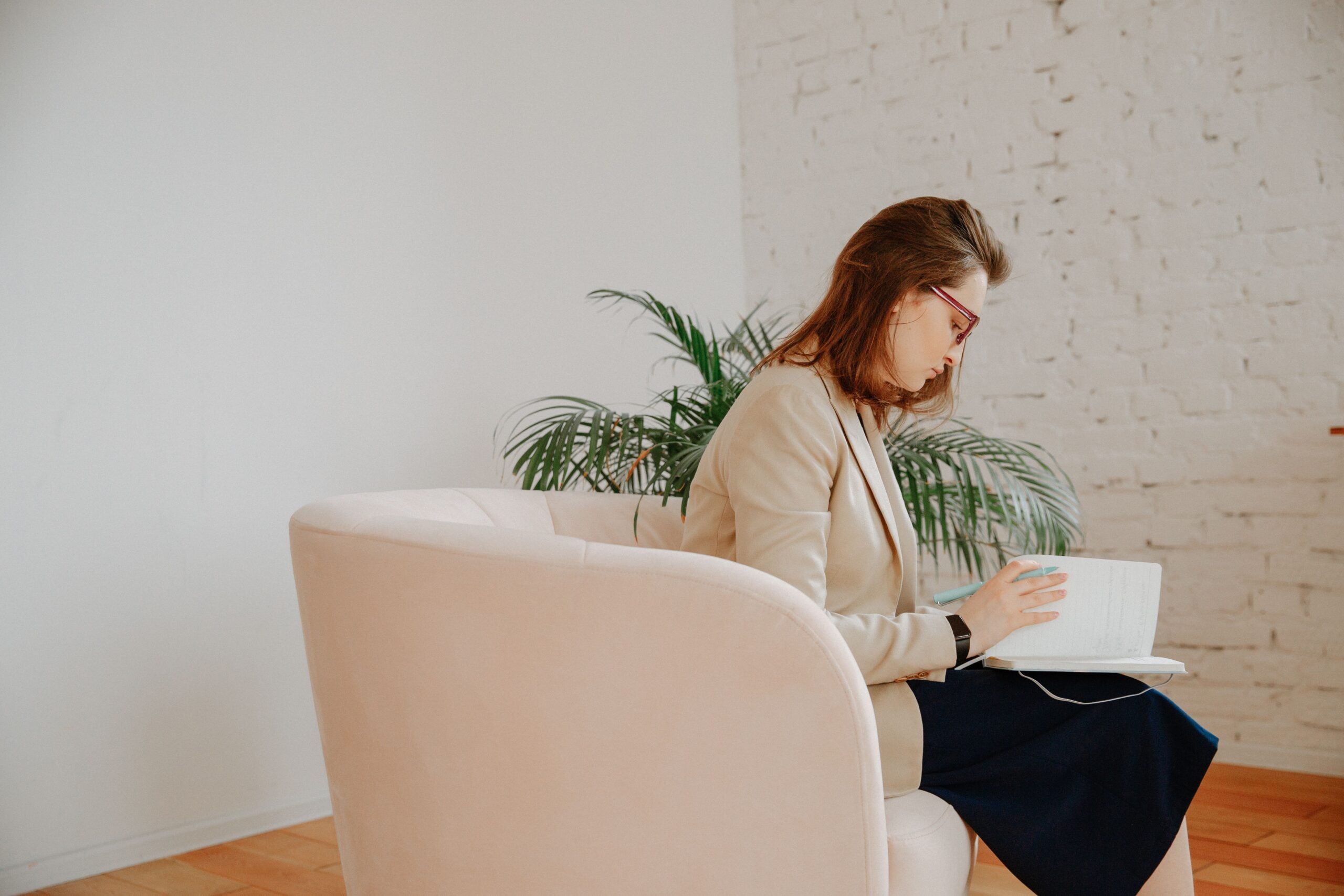 Behavioral health professional reviewing notes during a counseling session