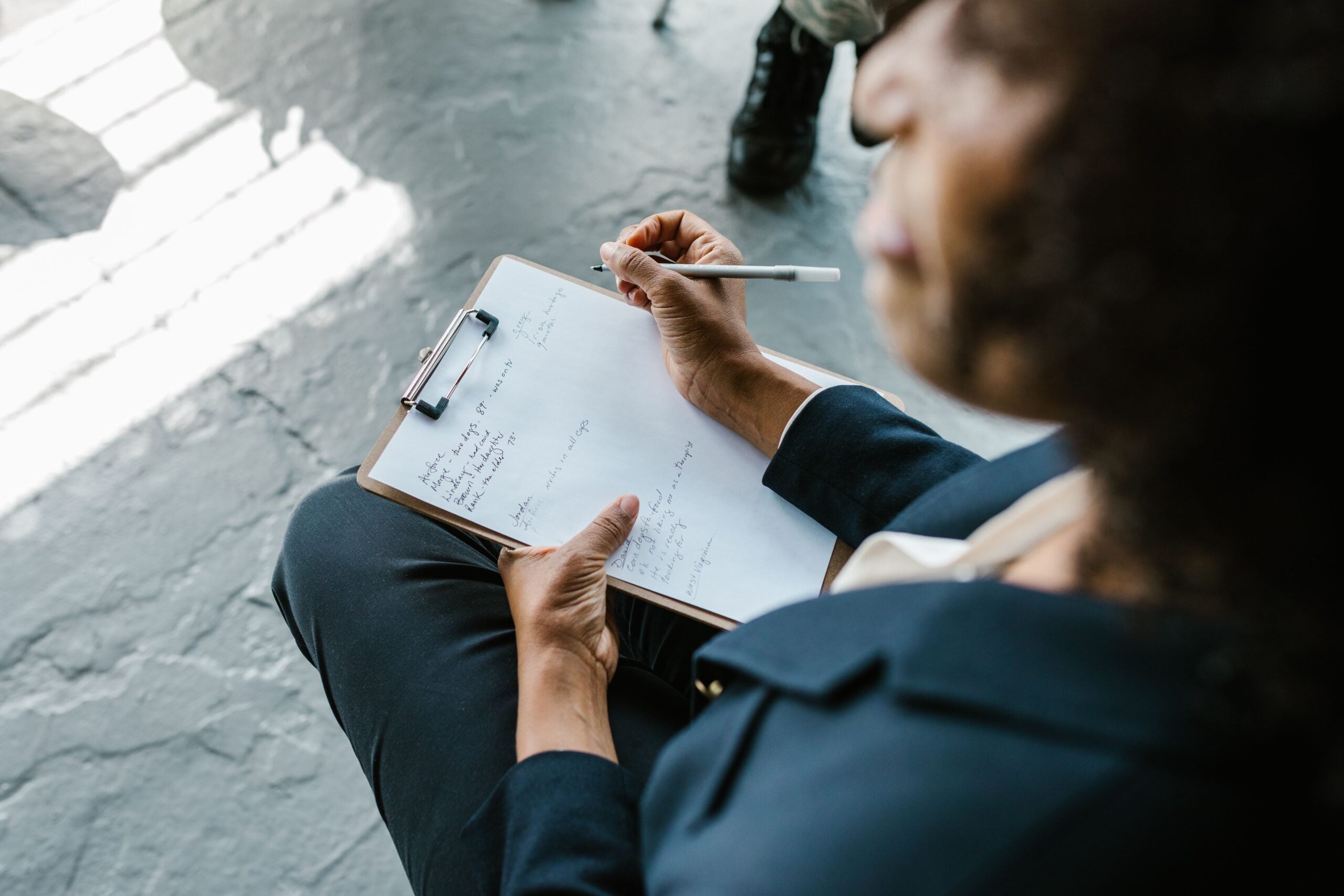 Behavioral health professional documenting notes during a client session