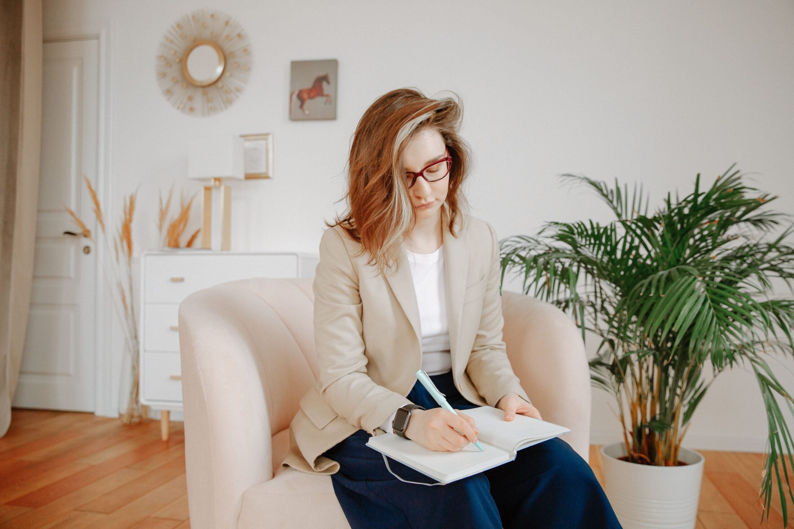 Behavioral health professional taking notes in a counseling office