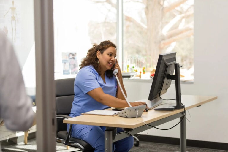 Behavioral health professional reviewing notes during a counseling session
