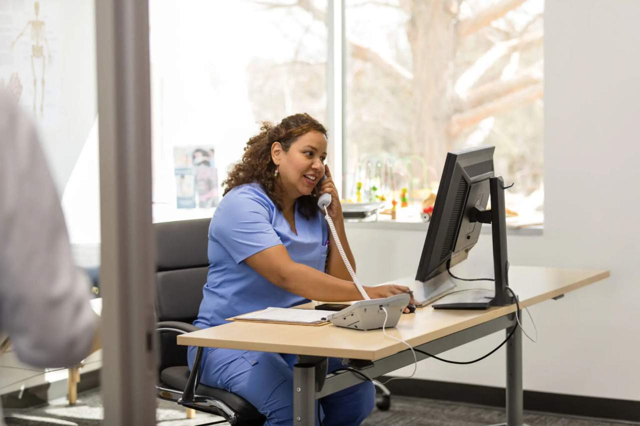 Behavioral health professional reviewing notes during a counseling session